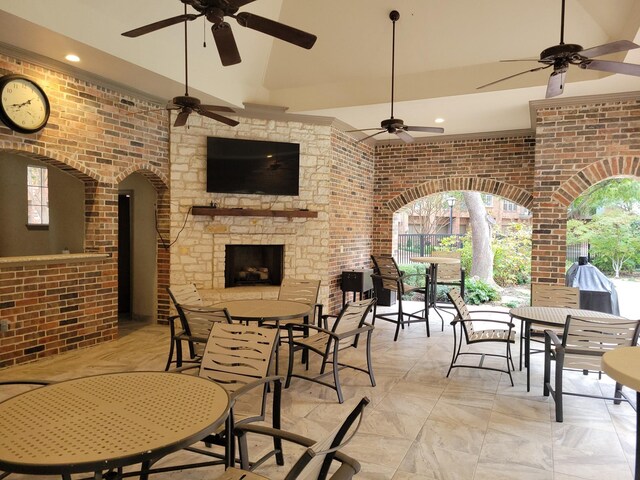 view of patio with an outdoor stone fireplace