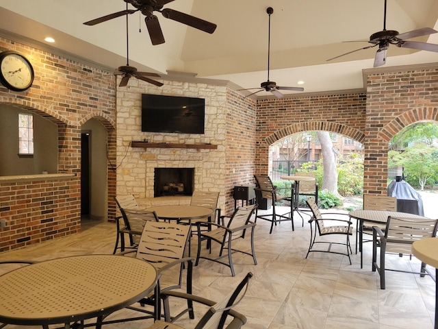 view of patio featuring an outdoor stone fireplace