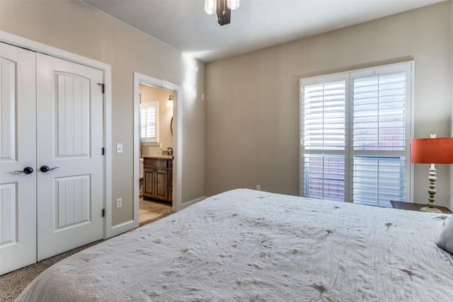 carpeted bedroom featuring connected bathroom, a closet, and ceiling fan