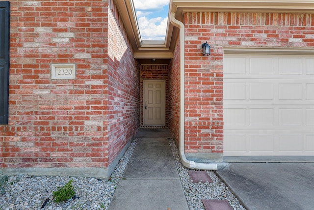 doorway to property with a garage