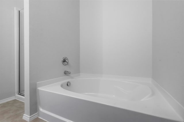 bathroom featuring tile patterned flooring and a bathtub