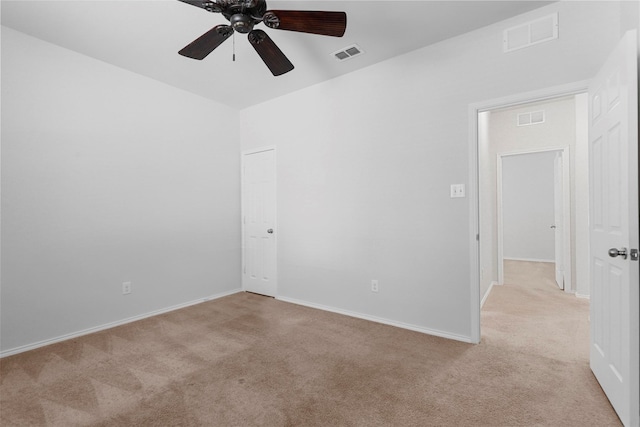 spare room featuring ceiling fan and light colored carpet