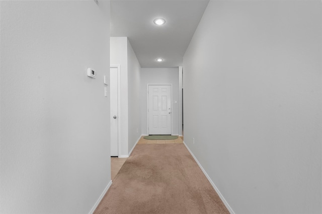 hallway featuring light carpet