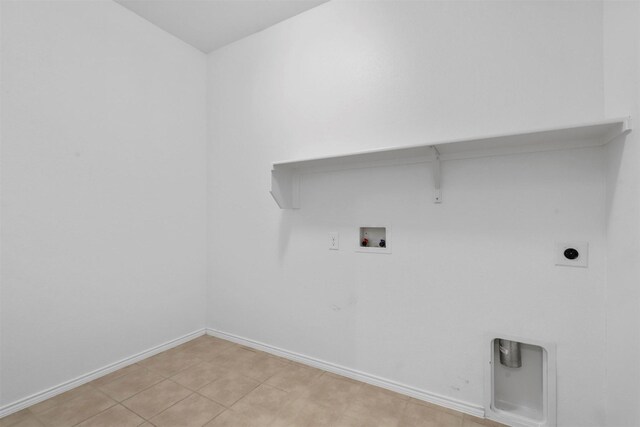 laundry area with washer hookup, hookup for an electric dryer, and light tile patterned flooring