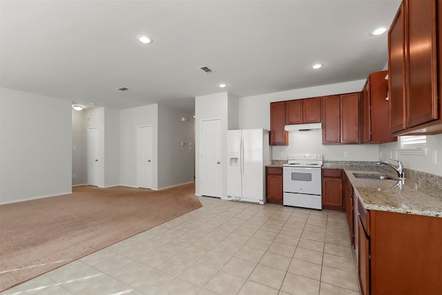 kitchen with light carpet, sink, white appliances, and light stone countertops