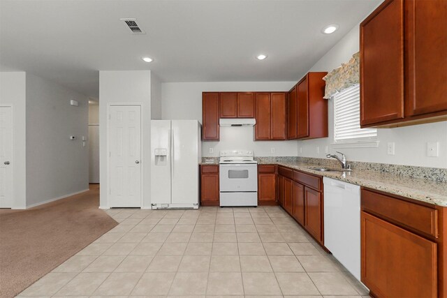 kitchen with white appliances, light carpet, sink, and light stone counters