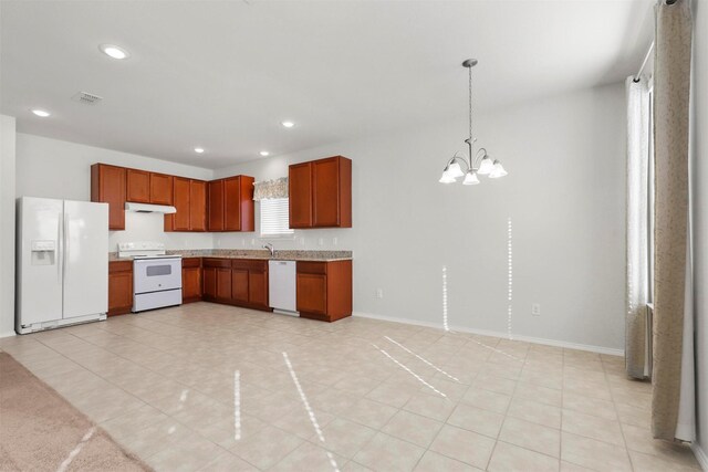 kitchen with white appliances, decorative light fixtures, light tile patterned flooring, and a notable chandelier