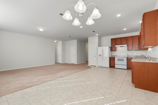 kitchen featuring sink, light tile patterned floors, white appliances, a notable chandelier, and pendant lighting