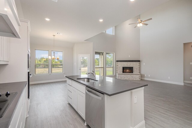 kitchen featuring dishwasher, high vaulted ceiling, white cabinetry, and sink