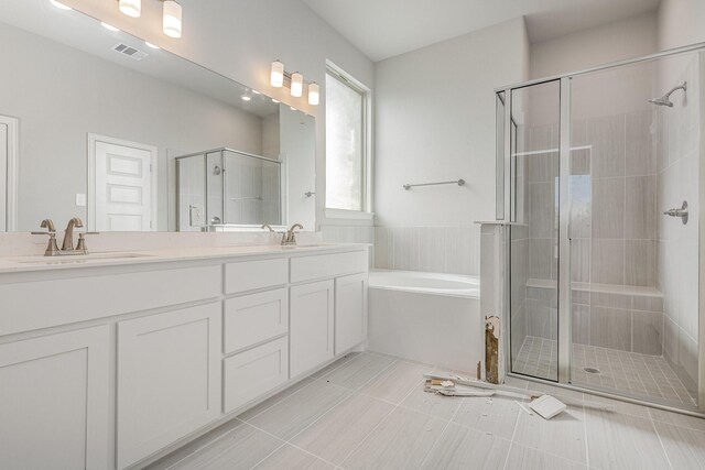 bathroom with vanity, tile patterned floors, and independent shower and bath