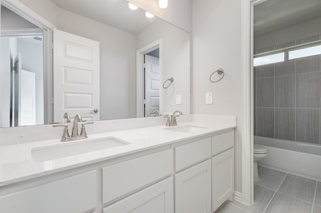 full bathroom with tile patterned flooring, vanity, toilet, and  shower combination