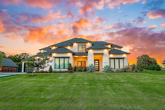 prairie-style home featuring a lawn