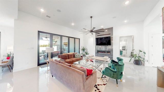 living room with ceiling fan, a fireplace, and french doors