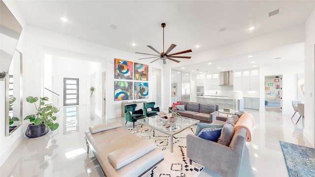 living room featuring ceiling fan and sink