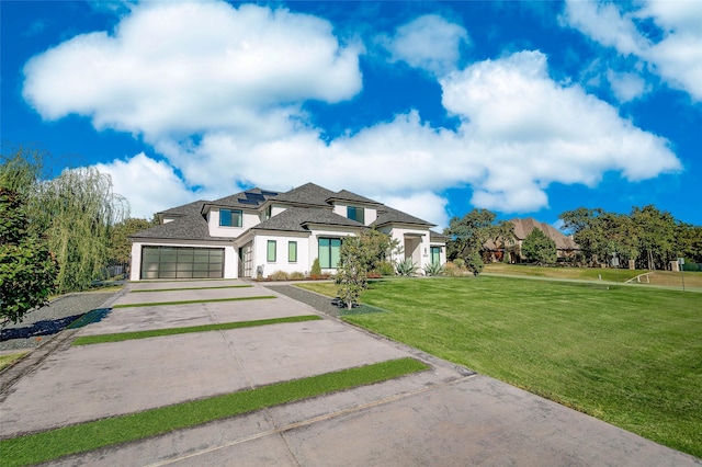 french country inspired facade featuring a front yard and a garage