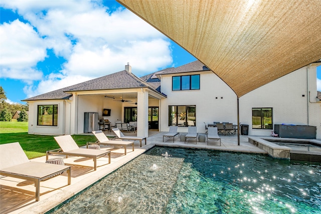 rear view of property featuring a pool with hot tub, ceiling fan, an outdoor hangout area, and a patio area