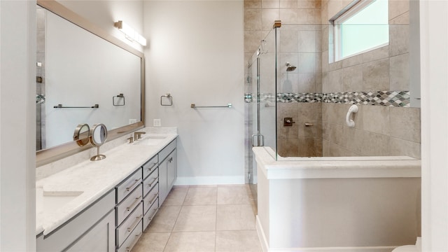 bathroom featuring vanity, a shower with shower door, and tile patterned flooring