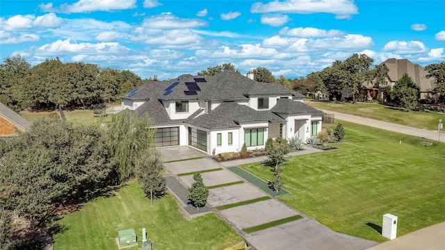 view of front of property featuring a front lawn and a garage