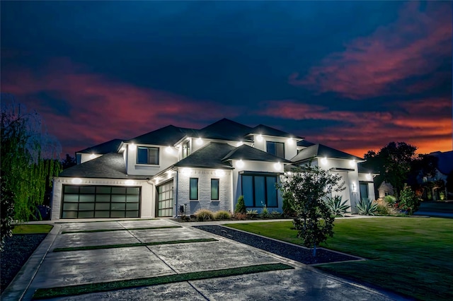 view of front of home with a yard and a garage