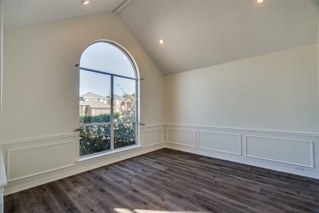 empty room with dark wood-type flooring and lofted ceiling