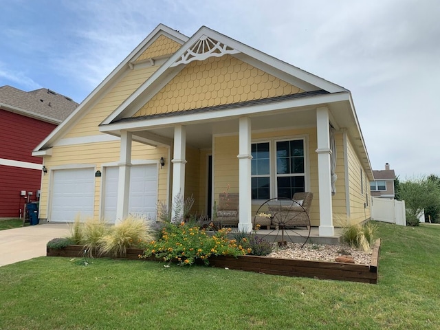 view of front facade with a garage, a porch, and a front lawn