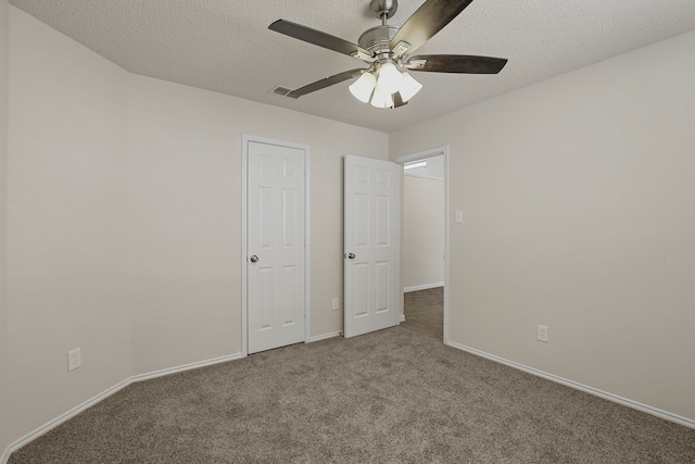 unfurnished bedroom with a textured ceiling, carpet flooring, and ceiling fan