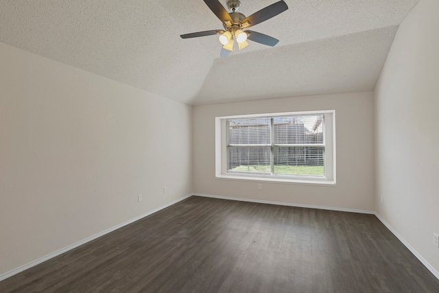 spare room featuring dark wood-type flooring, lofted ceiling, a textured ceiling, and ceiling fan