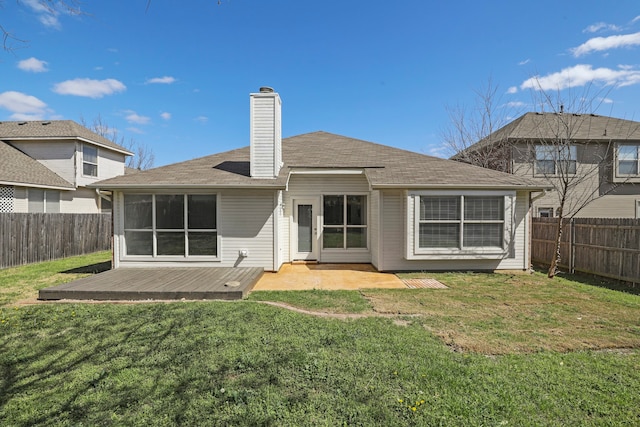 rear view of house featuring a yard and a wooden deck