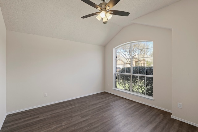 empty room featuring ceiling fan, dark hardwood / wood-style floors, a textured ceiling, and vaulted ceiling