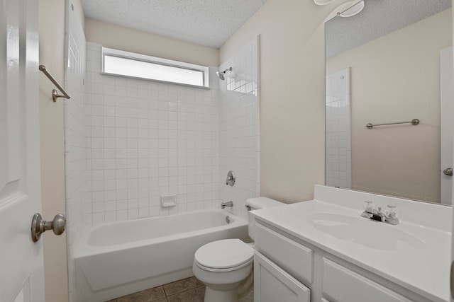 full bathroom with vanity, a textured ceiling, tile patterned flooring, toilet, and tiled shower / bath