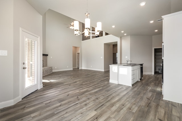 kitchen with white cabinets, a high ceiling, decorative light fixtures, and dark hardwood / wood-style flooring