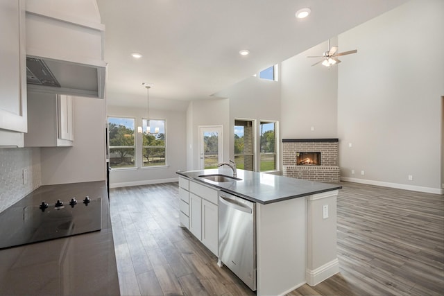 750 Serenity Ln, Red Oak, TX 75154 - kitchen with dishwasher, black electric stovetop, a brick fireplace, white cabinets, and dark wood-style flooring