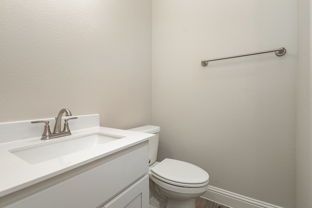 bathroom with toilet and vanity