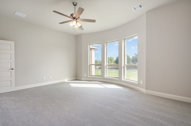 carpeted spare room with ceiling fan