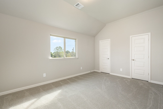 unfurnished bedroom featuring vaulted ceiling and carpet floors