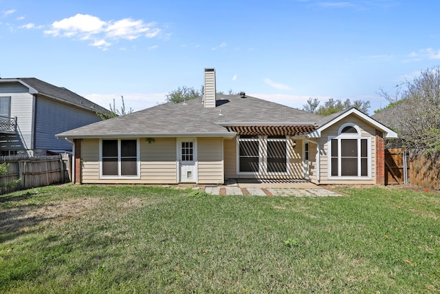 rear view of house with a yard