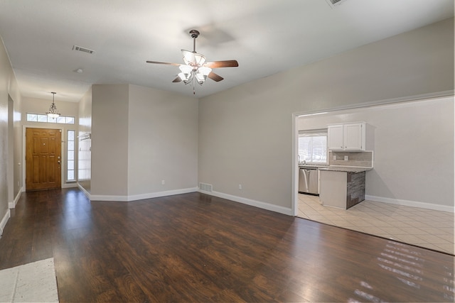 unfurnished living room featuring hardwood / wood-style flooring, ceiling fan, and plenty of natural light