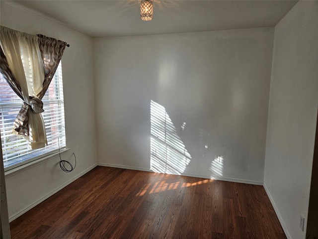 spare room featuring dark wood-type flooring