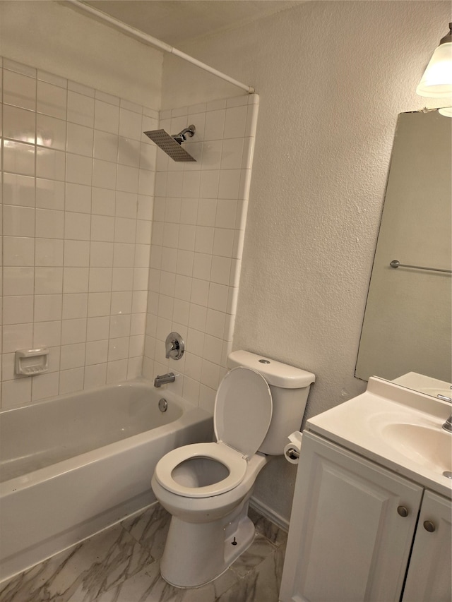 full bathroom featuring vanity, toilet, and tiled shower / bath