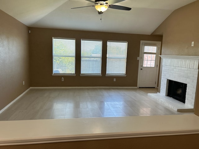 unfurnished living room featuring a fireplace, ceiling fan, vaulted ceiling, and light tile patterned flooring