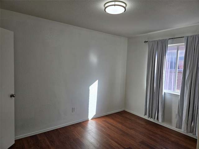 empty room with dark wood-type flooring