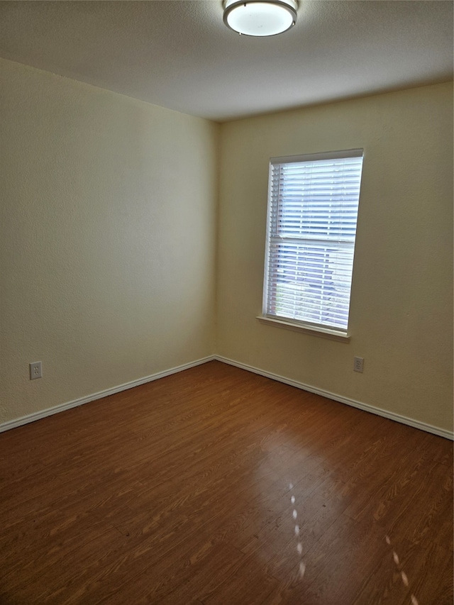 empty room featuring dark hardwood / wood-style floors