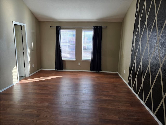 empty room with dark wood-type flooring