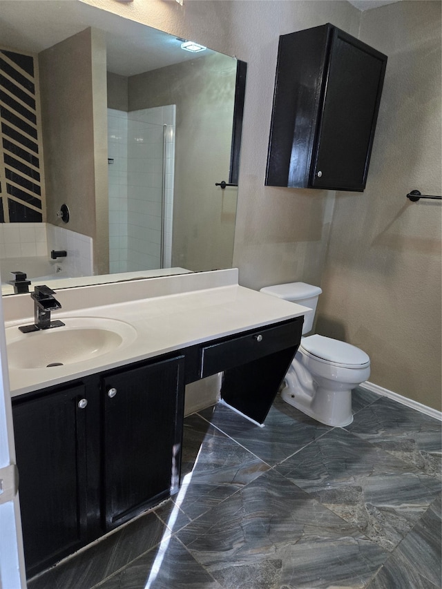 bathroom featuring a shower with door, vanity, and toilet