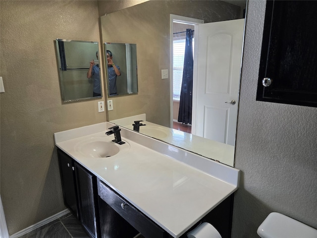 bathroom with toilet and vanity