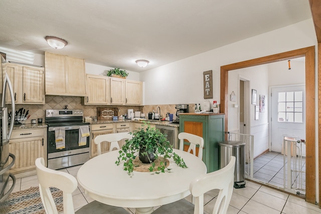 kitchen with stainless steel appliances, light tile patterned flooring, light brown cabinets, and decorative backsplash