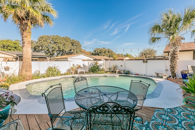 view of swimming pool featuring a wooden deck