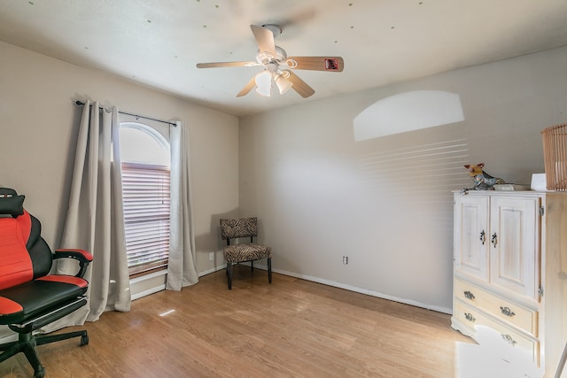 living area with ceiling fan and light wood-type flooring