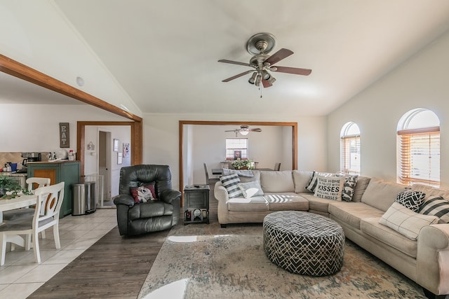 tiled living room featuring vaulted ceiling and ceiling fan