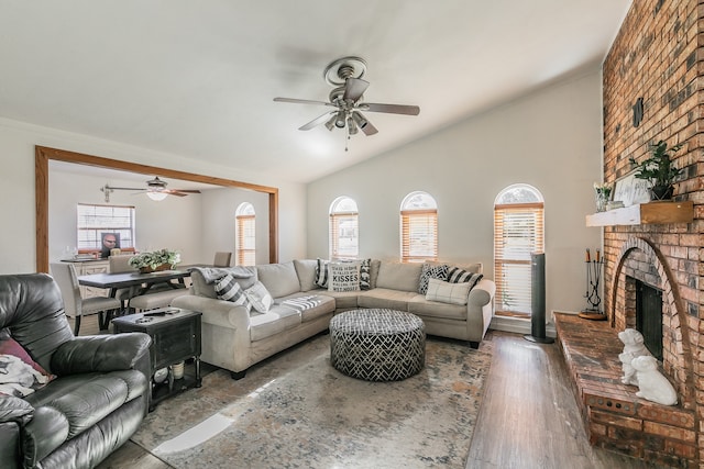 living room with hardwood / wood-style flooring, plenty of natural light, and vaulted ceiling